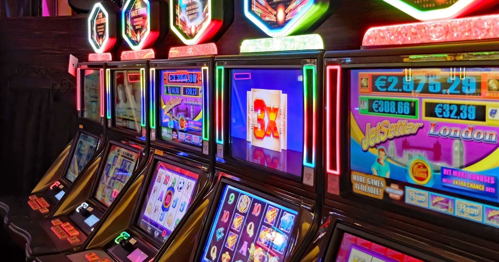 Row of lit-up casino slot machines